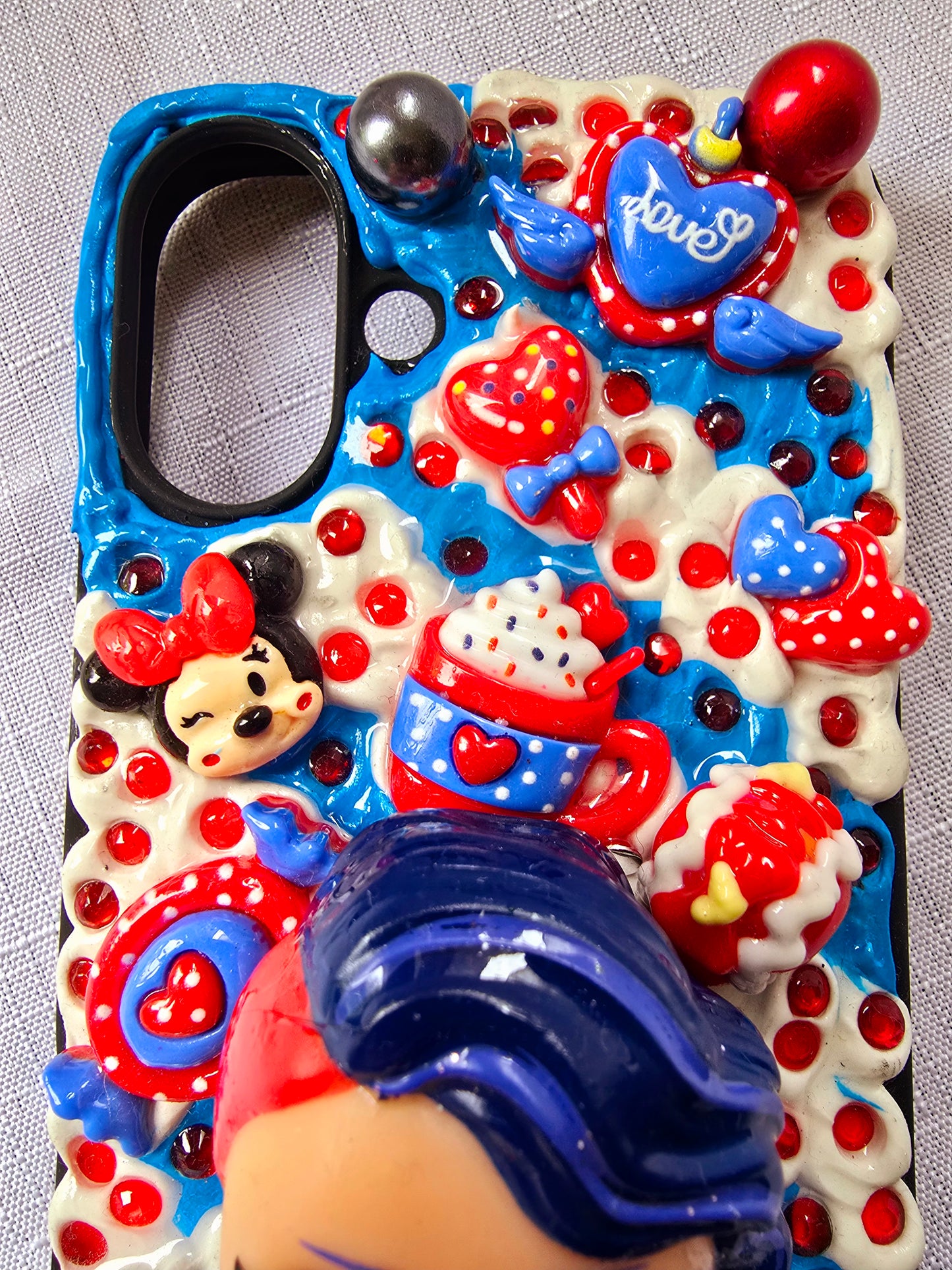 A handmade red and blue iPhone 16 plus phone case