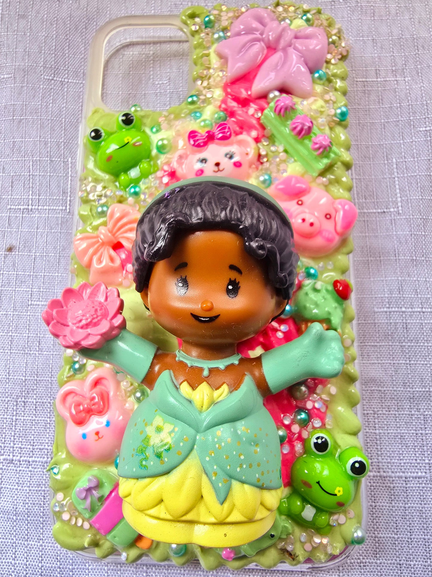 Handmade iPhone 11 phone case in green and pink, featuring a princess theme with floral, animal, and bow accents – cute and whimsical design.