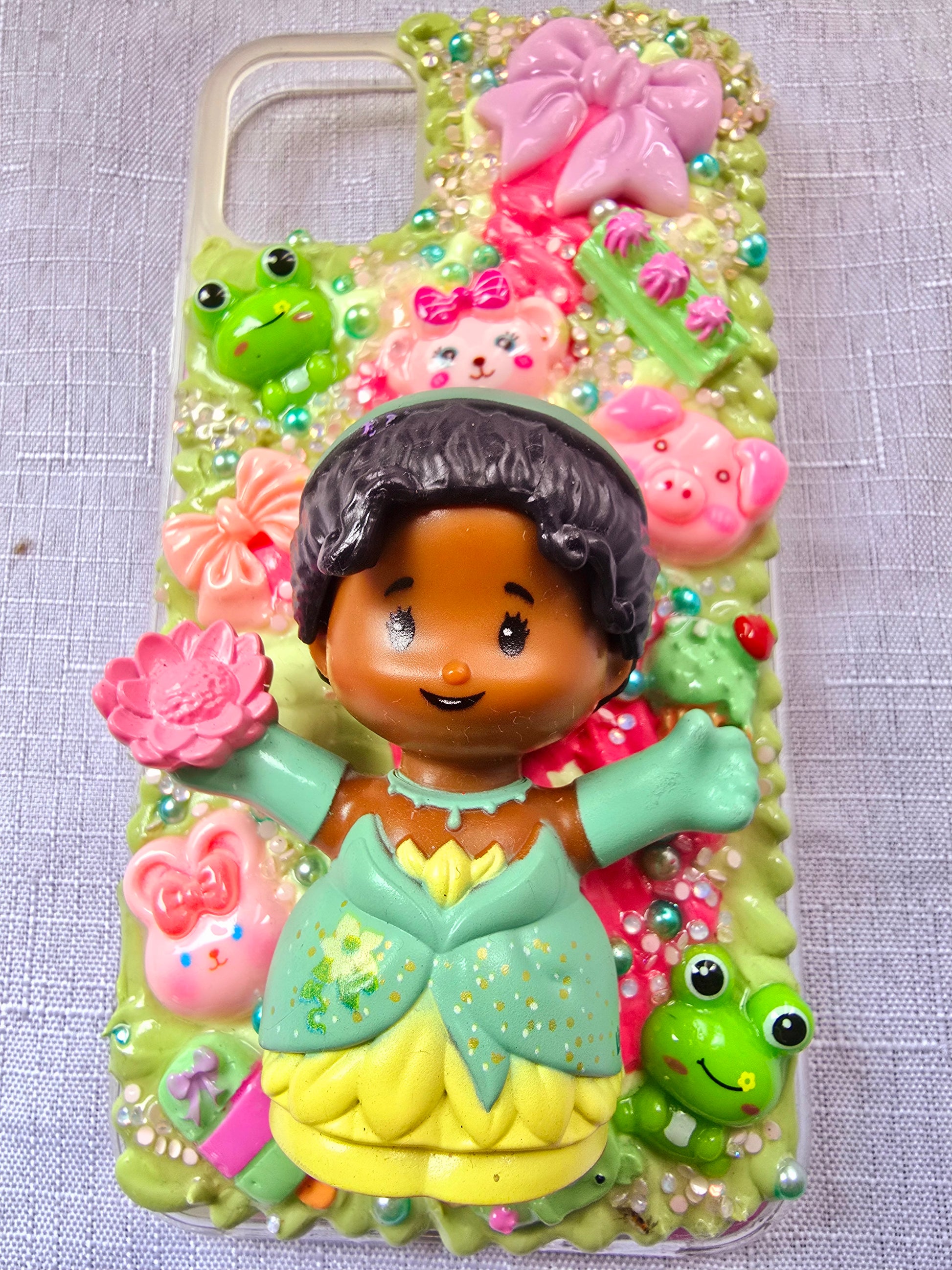 Handmade iPhone 11 phone case in green and pink, featuring a princess theme with floral, animal, and bow accents – cute and whimsical design.