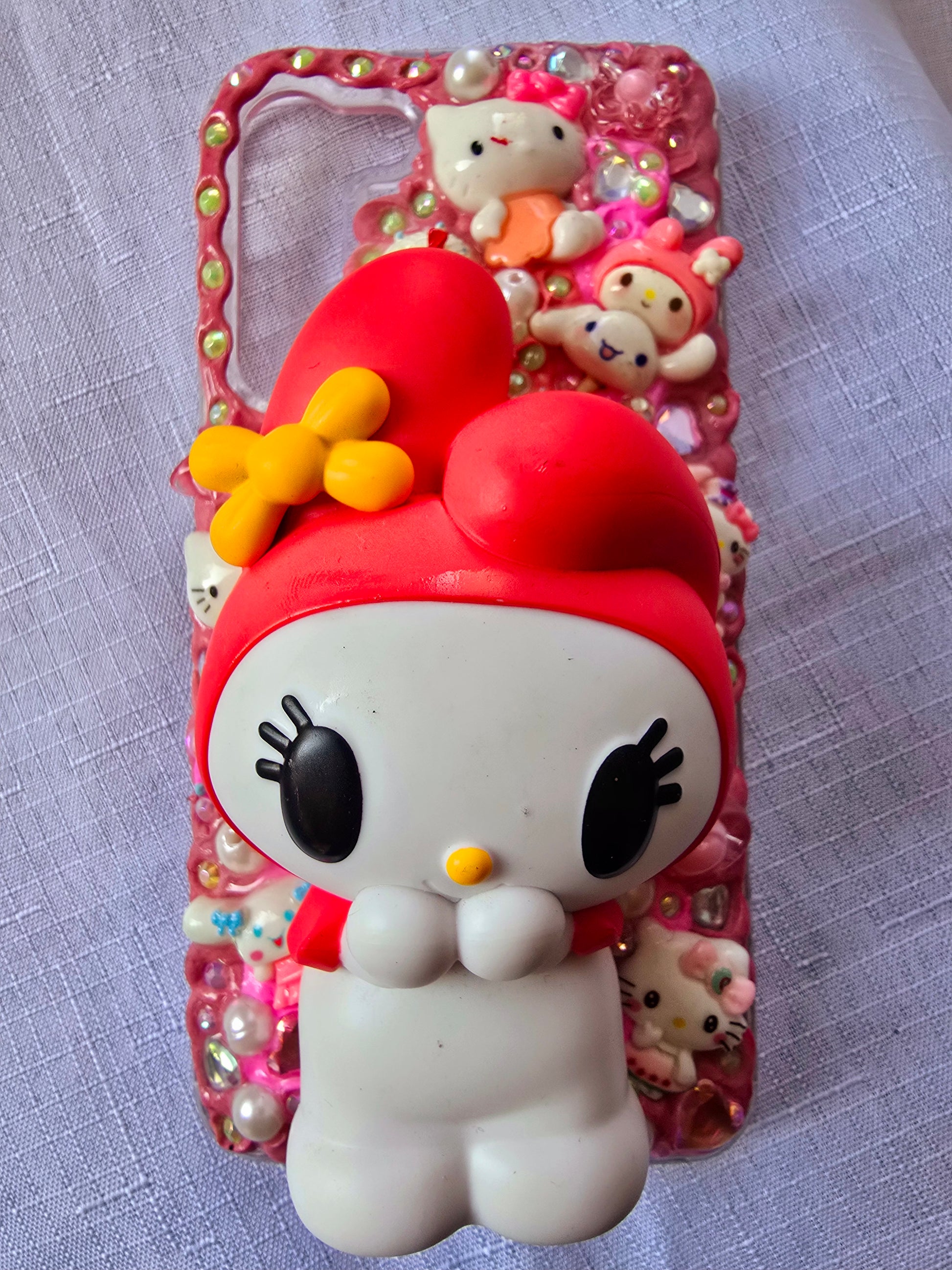 Handmade Samsung S23 Plus phone case featuring a My Melody theme in pink, white, and yellow with cute 3D decorations and kawaii charm accents.