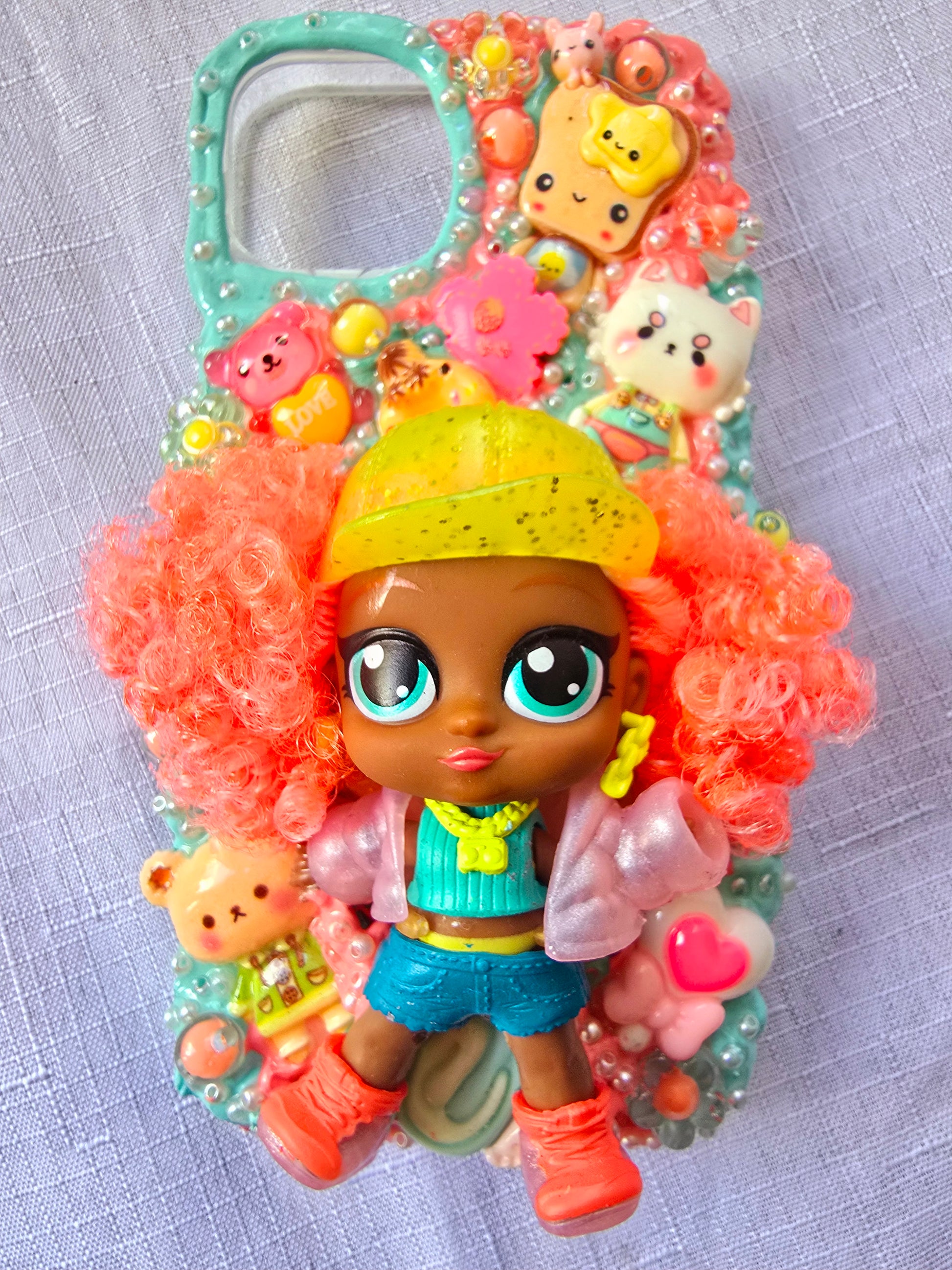 A handmade blue and pink iPhone 13 phone case