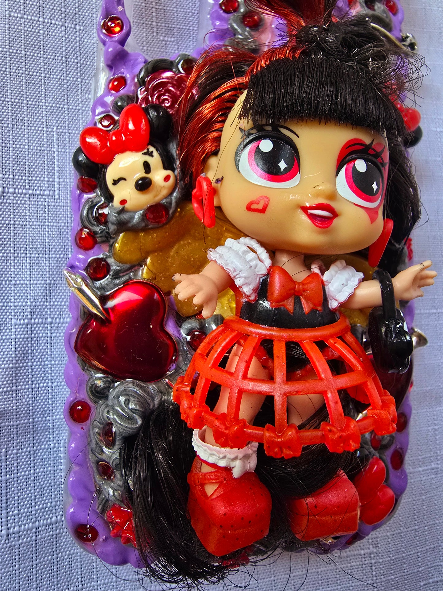 Handmade Samsung S23 Plus phone case with gothic and doll-inspired design, featuring red and black accents, heart charms, and 3D figure on a purple base.