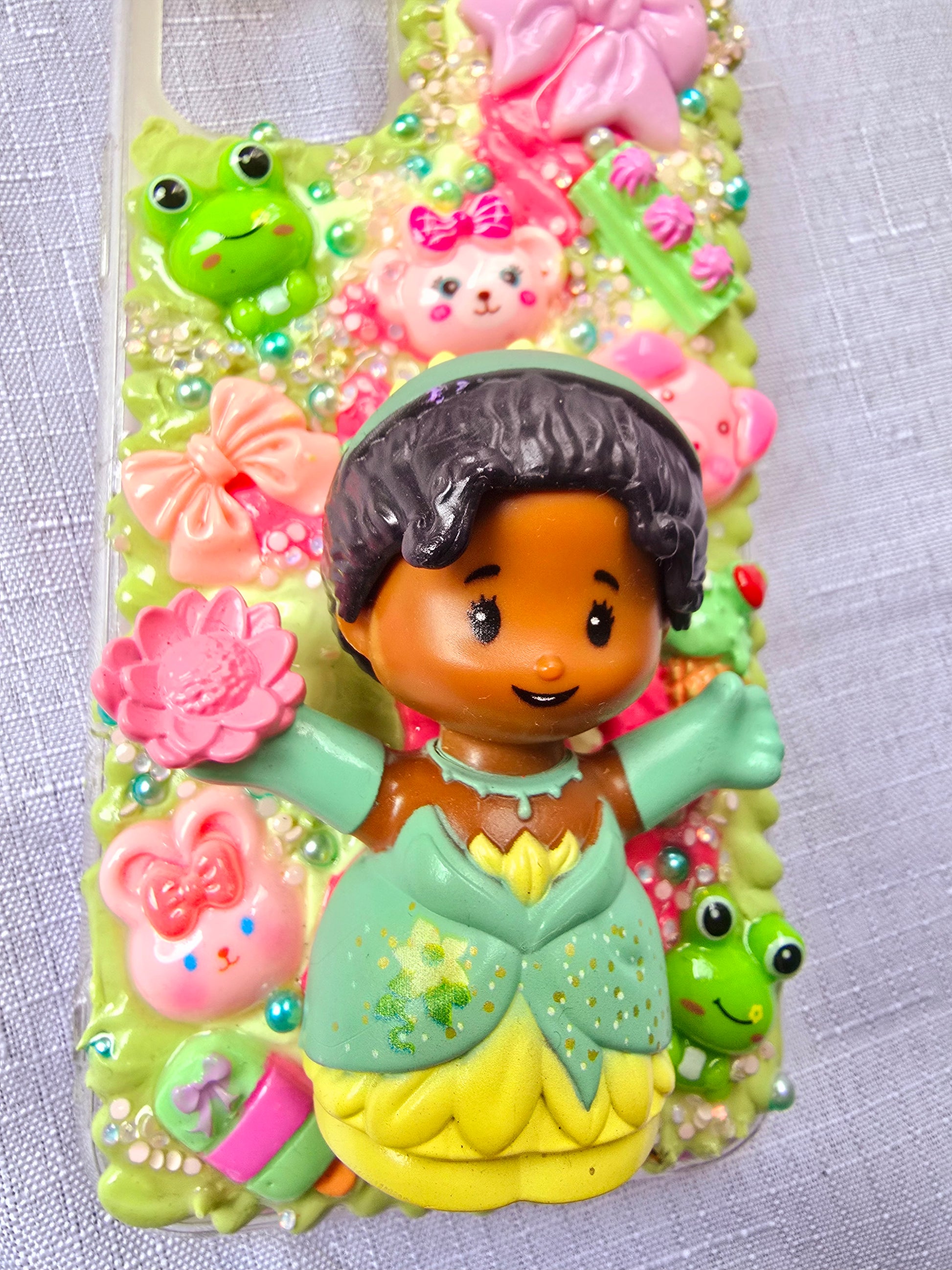 Handmade iPhone 11 phone case in green and pink, featuring a princess theme with floral, animal, and bow accents – cute and whimsical design.