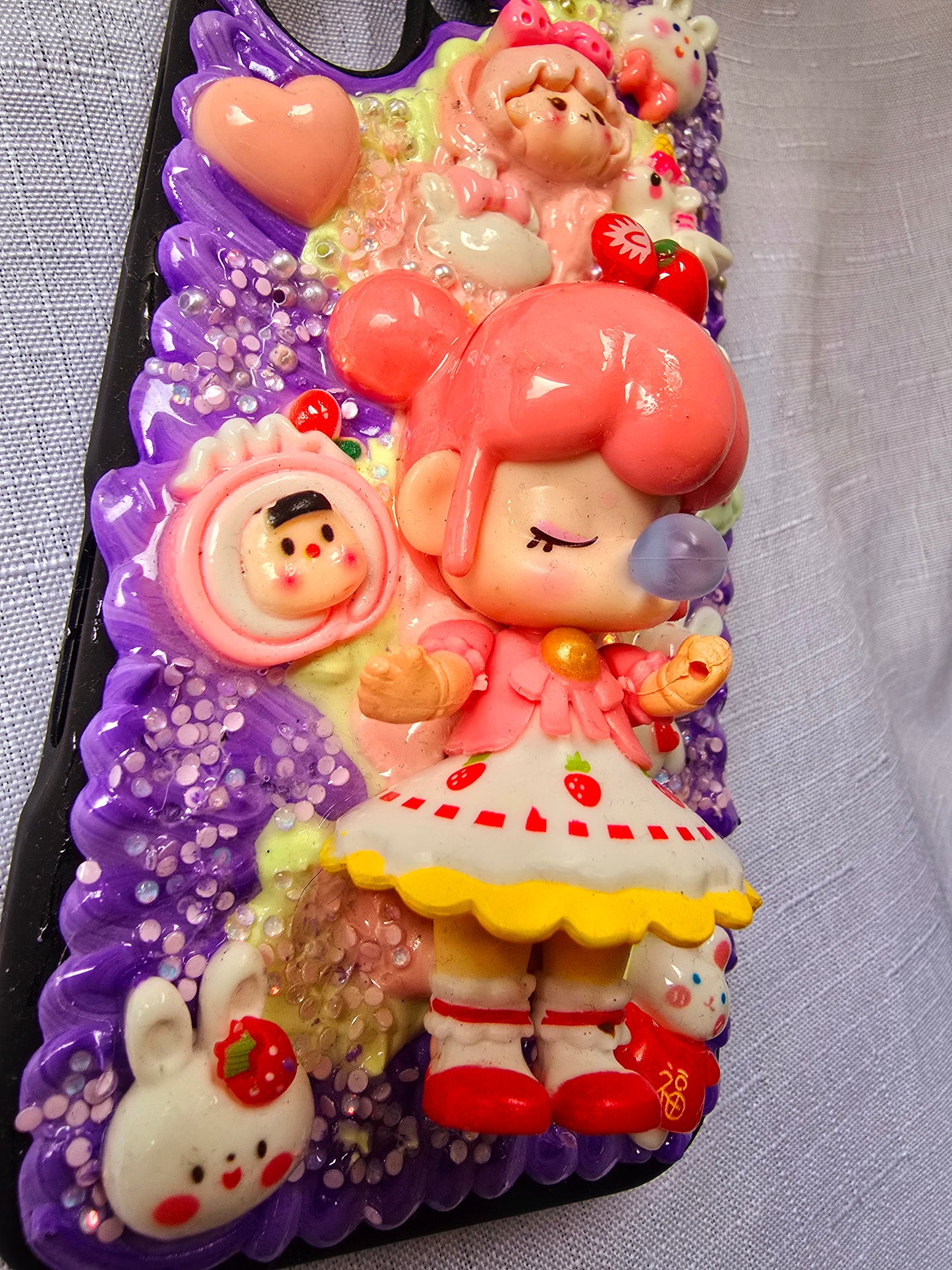 A handmade pink and purple iPhone 16 plus phone case 
