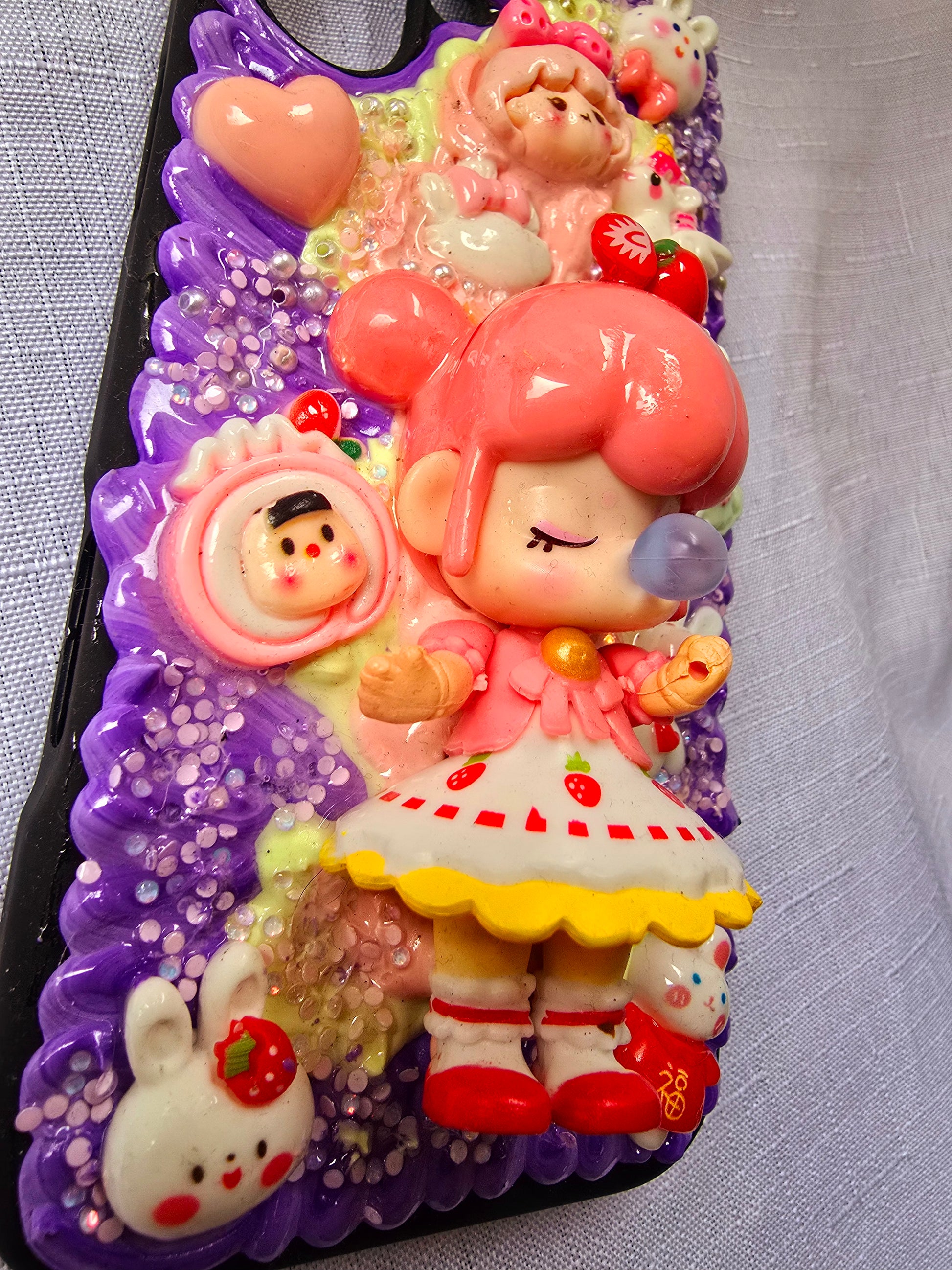 A handmade pink and purple iPhone 16 plus phone case 