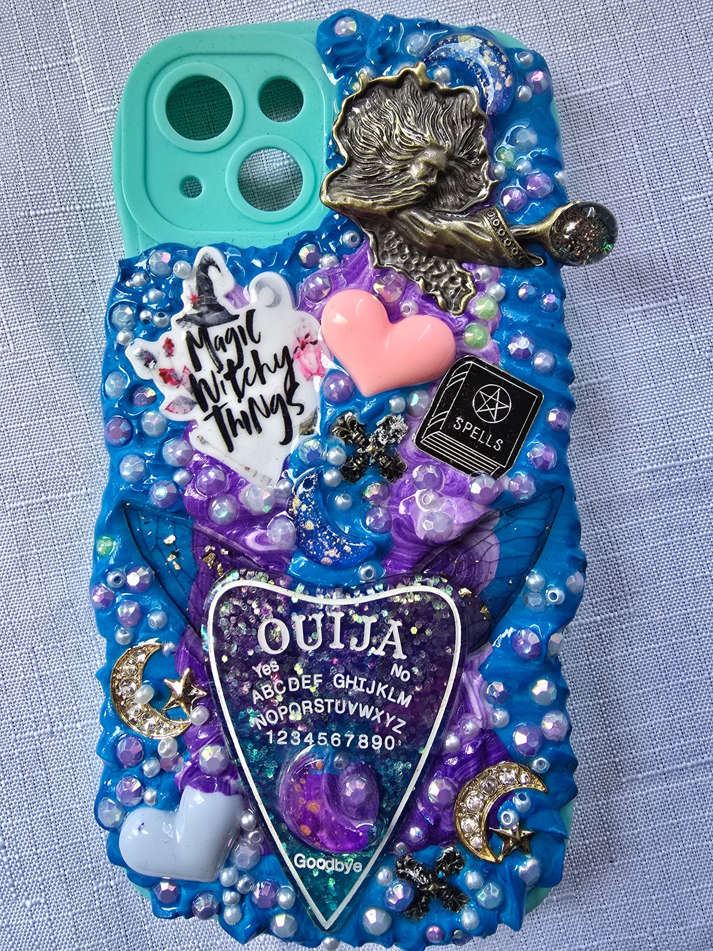 Handmade iPhone 13 phone case in blue and purple with a spiritual and witchy aesthetic, featuring mystical and magical-themed decorations.