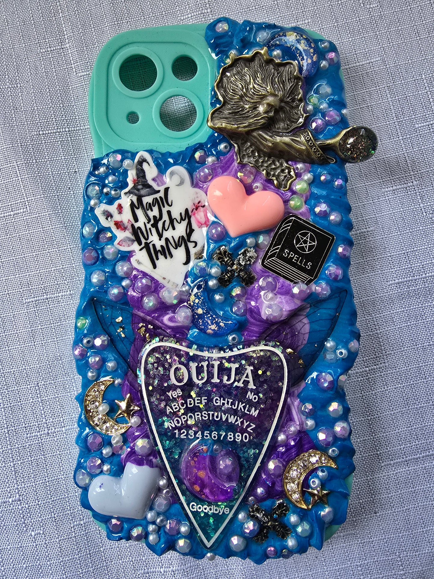 Handmade iPhone 13 phone case in blue and purple with a spiritual and witchy aesthetic, featuring mystical and magical-themed decorations