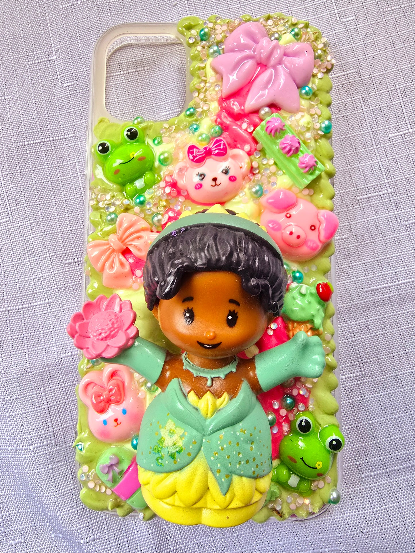 Handmade iPhone 11 phone case in green and pink, featuring a princess theme with floral, animal, and bow accents – cute and whimsical design.
