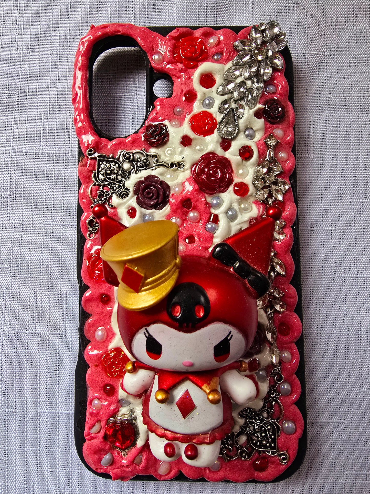 A unique, original handmade red, black, and silver kuromi inspired iPhone 16 plus phone case