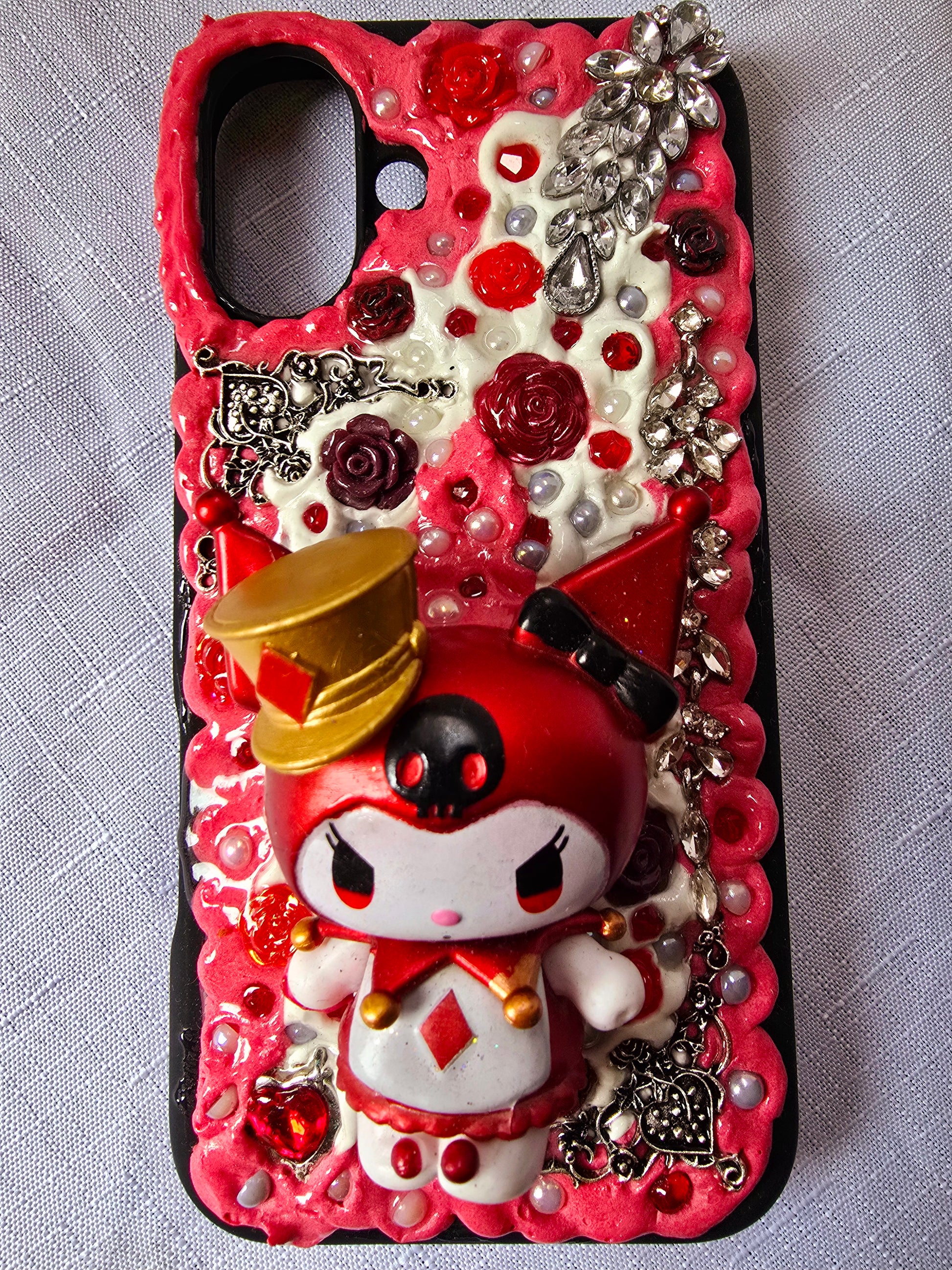 A unique, original handmade red, black, and silver kuromi inspired iPhone 16 plus phone case