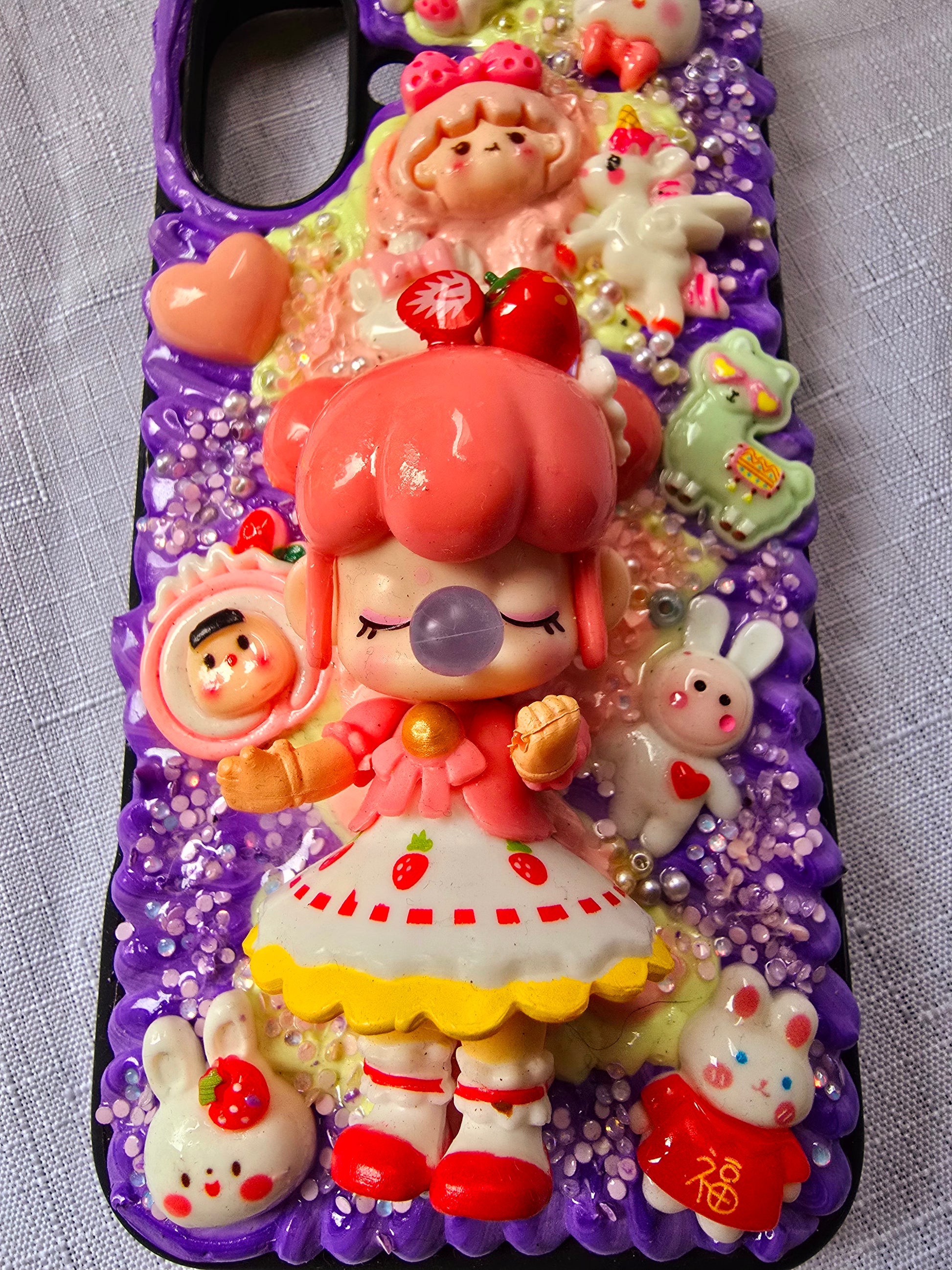 A handmade pink and purple iPhone 16 plus phone case 