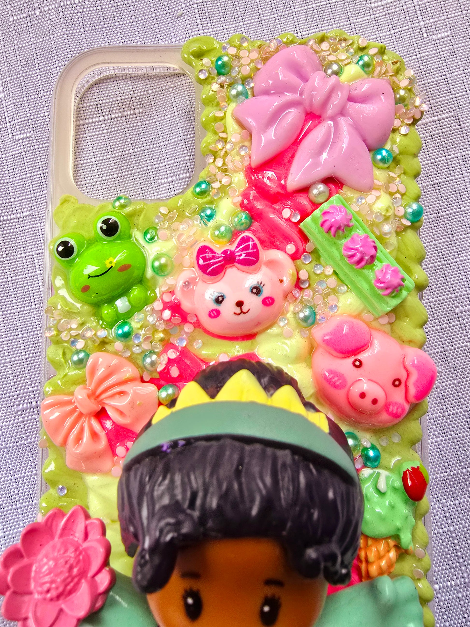 Handmade iPhone 11 phone case in green and pink, featuring a princess theme with floral, animal, and bow accents – cute and whimsical design.