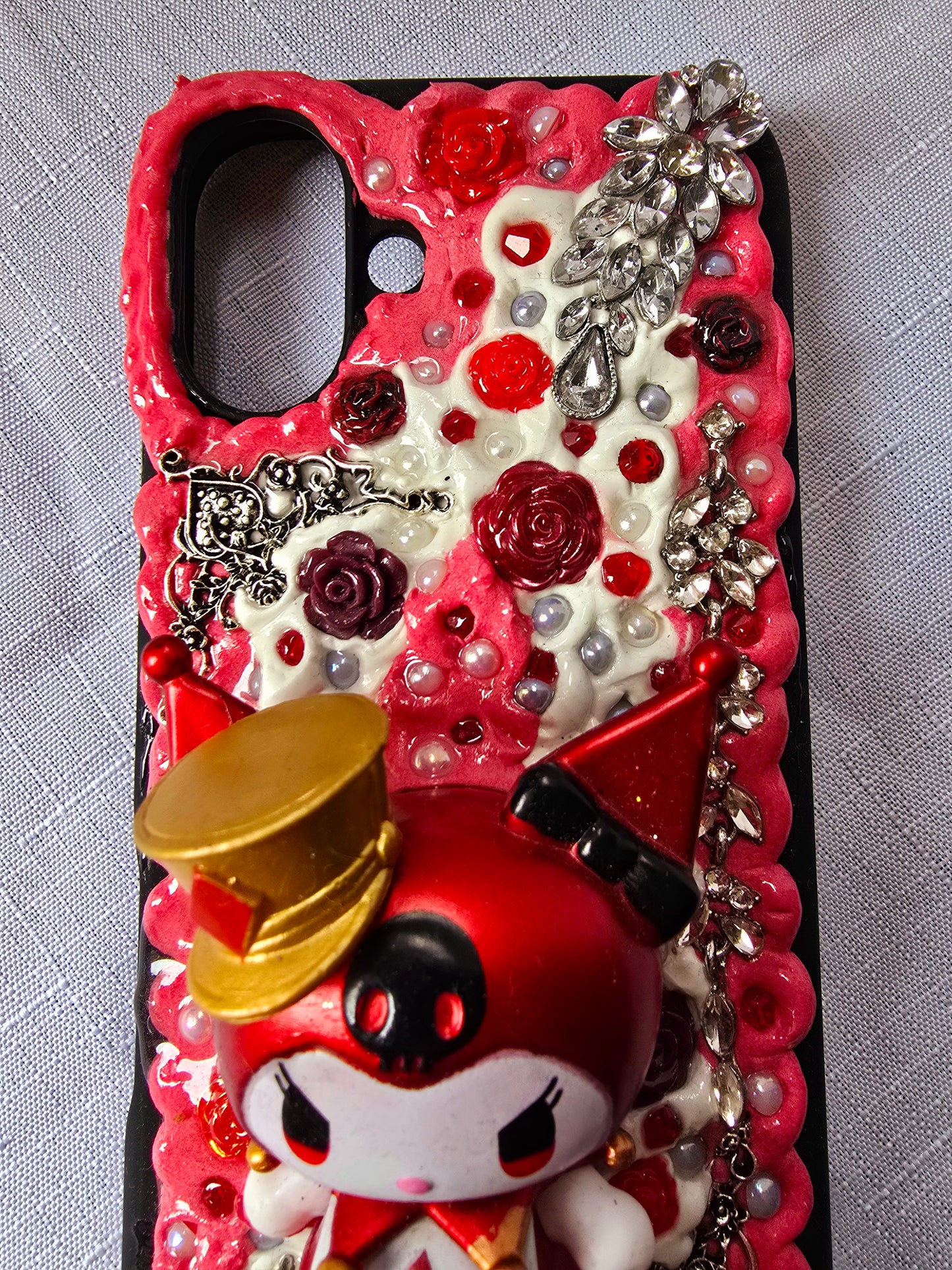 A unique, original handmade red, black, and silver kuromi inspired iPhone 16 plus phone case