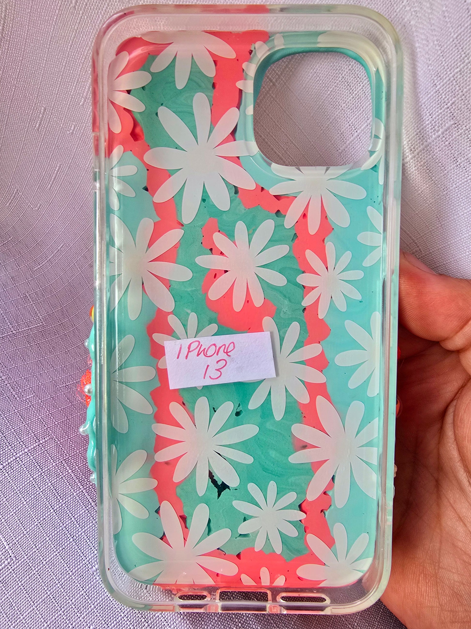 A handmade blue and pink iPhone 13 phone case
