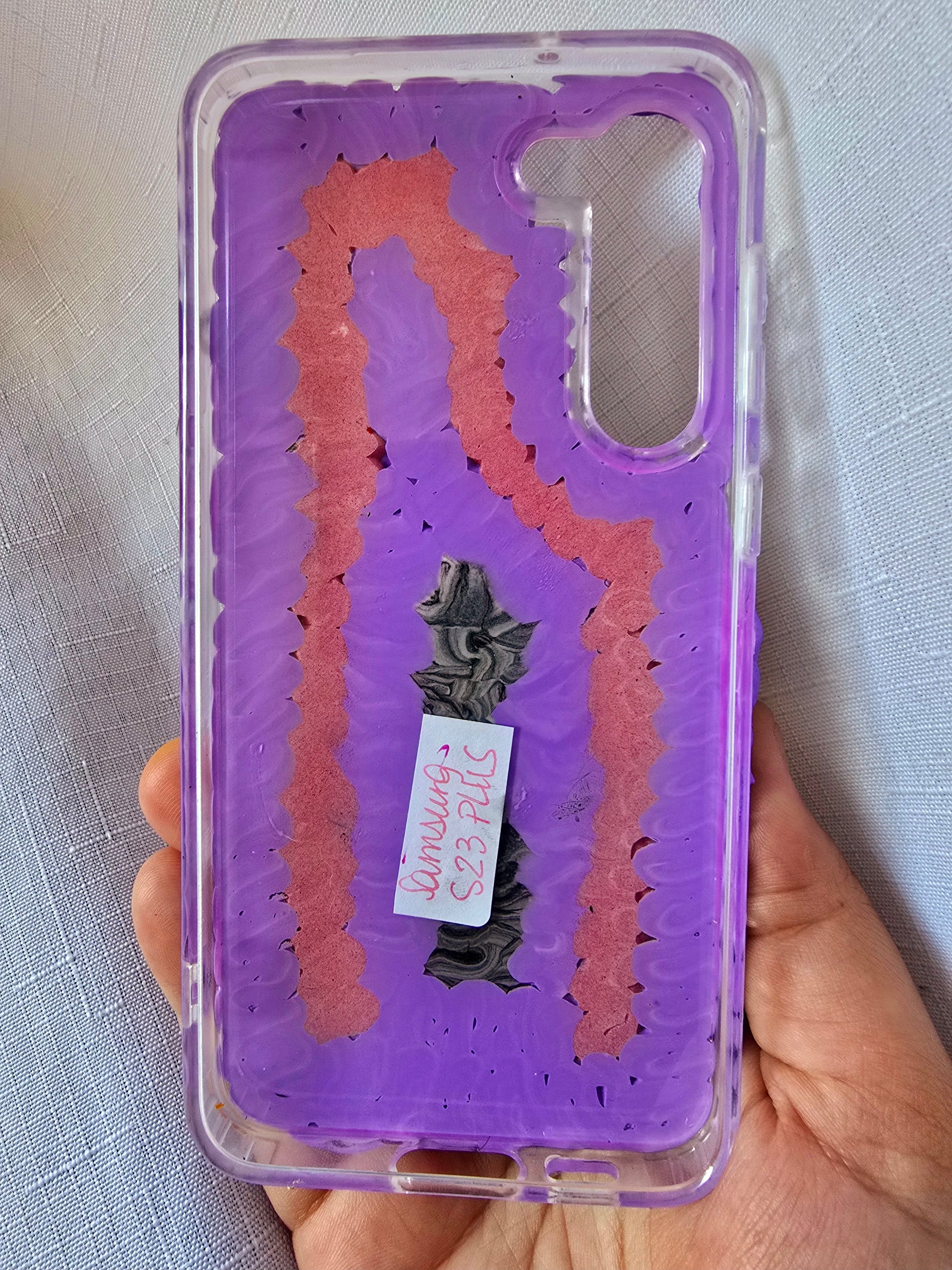 Handmade Samsung S23 Plus phone case with gothic and doll-inspired design, featuring red and black accents, heart charms, and 3D figure on a purple base.