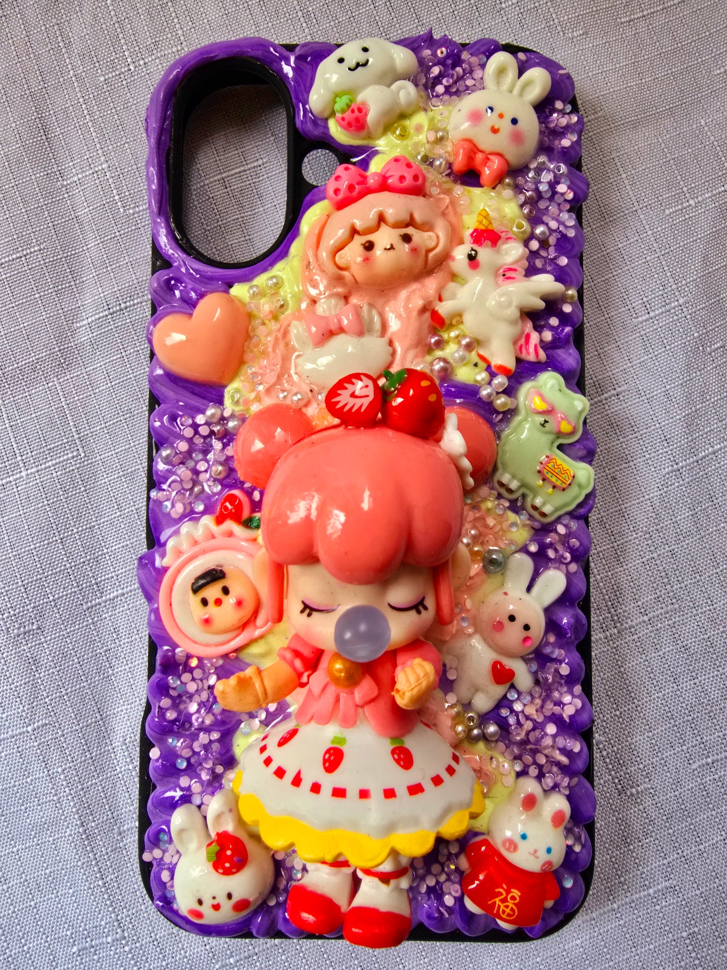 A handmade pink and purple iPhone 16 plus phone case 